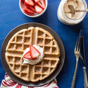 Churro Waffles with Cayenne Whipped Cream - delicious waffles sprinkled generously with cinnamon and sugar, and topped with a homemade cayenne cinnamon whipped cream. Perfect for brunch! | healthynibblesandbits.com