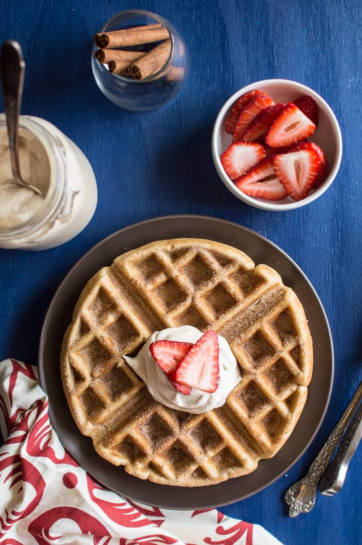 Churro Waffles with Cayenne Whipped Cream - delicious waffles sprinkled generously with cinnamon and sugar, and topped with a homemade cayenne cinnamon whipped cream. Perfect for brunch! | healthynibblesandbits.com