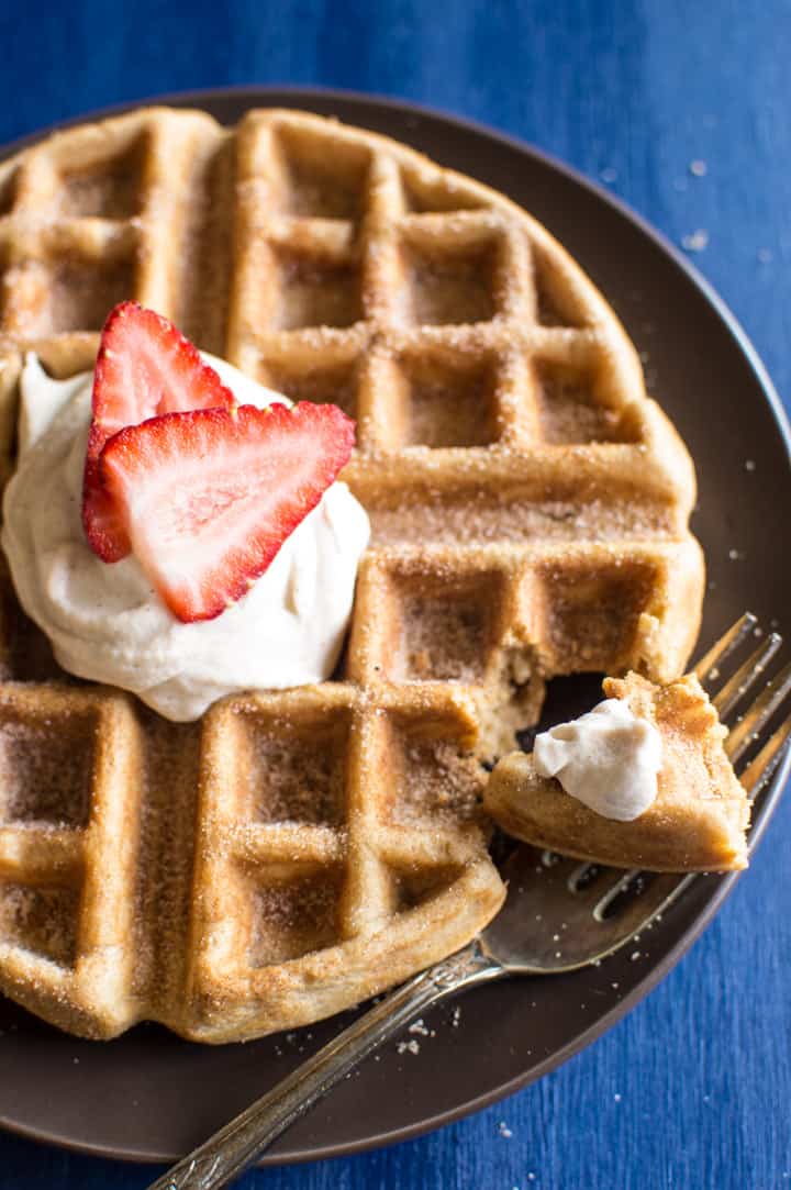 Churro Waffles with Cayenne Whipped Cream - delicious waffles sprinkled generously with cinnamon and sugar, and topped with a homemade cayenne cinnamon whipped cream. Perfect for brunch! | healthynibblesandbits.com