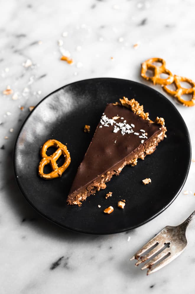 Five-Ingredient Chocolate Coconut Tart with Pretzel Crust - this rich gluten-free dessert is a must make for your next gathering! by Lisa Lin of Healthy Nibbles & Bits