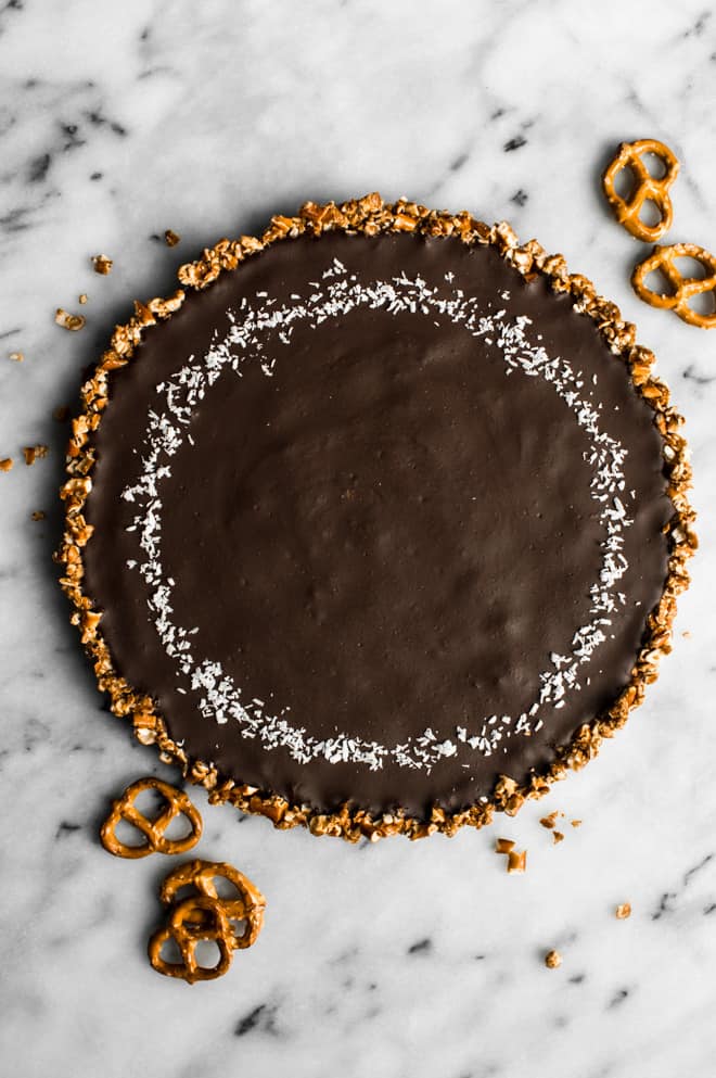 Five-Ingredient Chocolate Coconut Tart with Pretzel Crust - this rich gluten-free dessert is a must make for your next gathering! by Lisa Lin of Healthy Nibbles & Bits