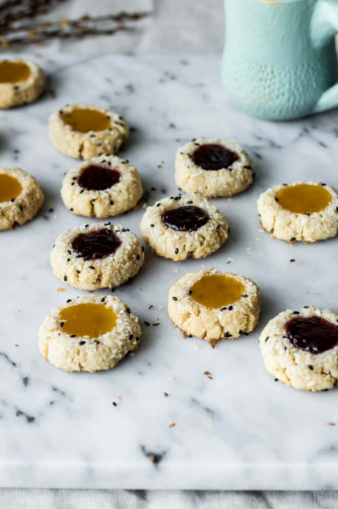 Easy Gluten-Free Coconut Thumbprint Cookies that are made with less than 10 ingredients! by Lisa Lin of healthynibblesandbits.com