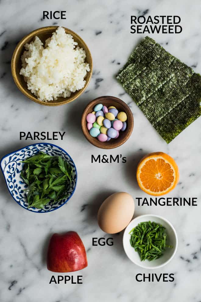 Easy Easter Bunny Food Art - made with rice, an apple, sushi seaweed, parsley, an egg, and M&M's! by @healthynibs