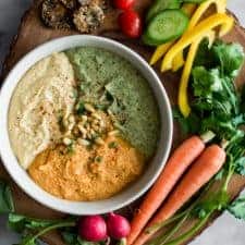 Perfect Hummus Three Ways - Roasted Garlic Hummus, Carrot Harissa Hummus, and Cilantro Jalapneo Hummus - it's a great protein-packed dip for pre- and post-workout! by @healthynibs