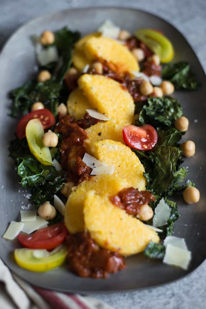 Pan Fried Polenta with Roasted Kale and Chickpeas - topped with tomatoes and parmesan cheese, this is the perfect light gluten-free dinner! Made with just 6 ingredients! by @healthynibs