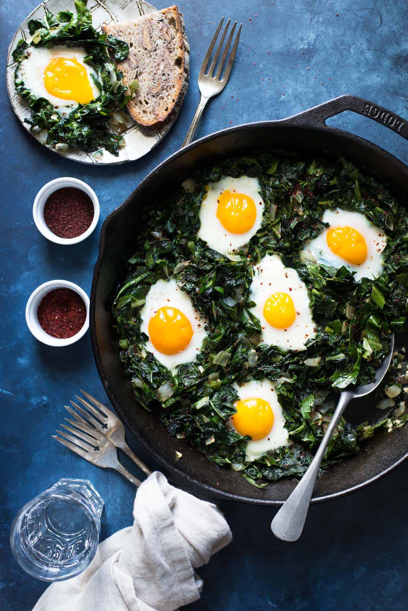 Green Shakshuka - a healthy breakfast dish filled with kale, collard greens and sunny side up eggs. An easy gluten-free meal!