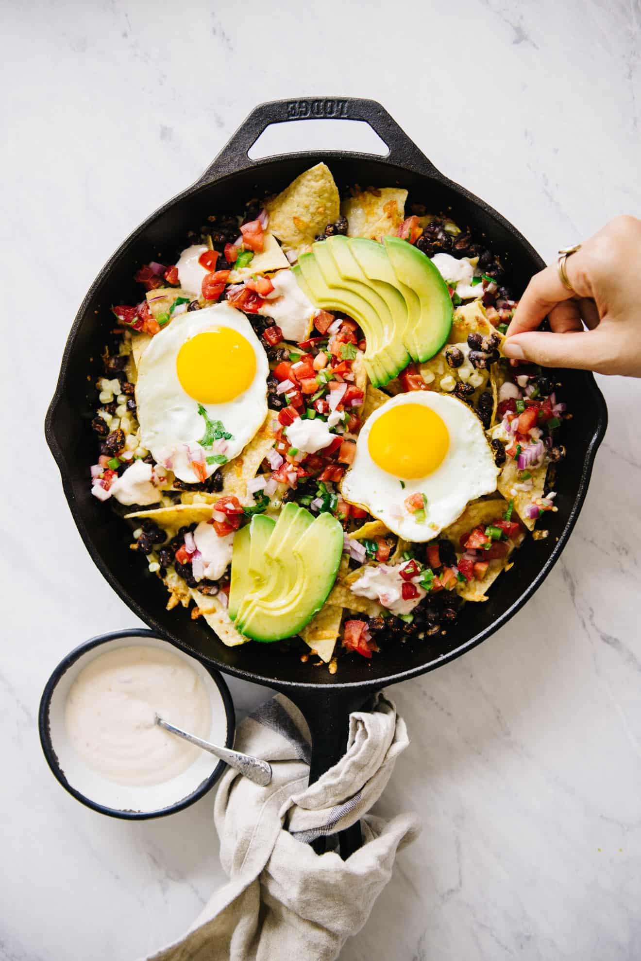 nachos with eggs on top in a cast iron pan! Perfect for brunch