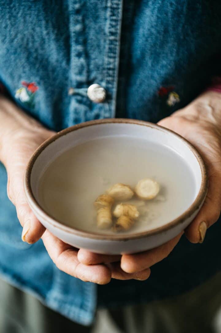 Mama Lin holding a bowl of ginseng tea