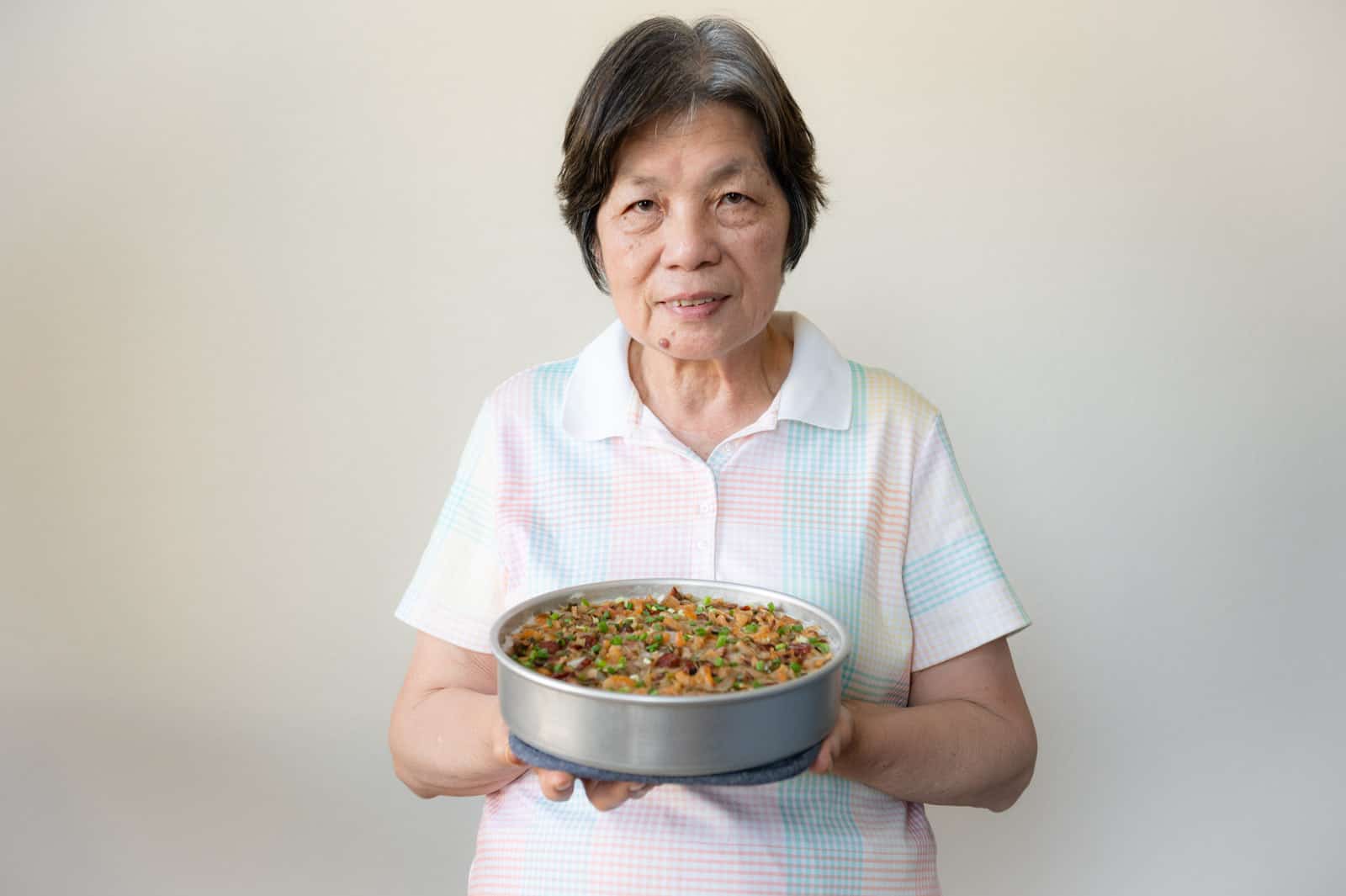 Mama Lin holding taro cake