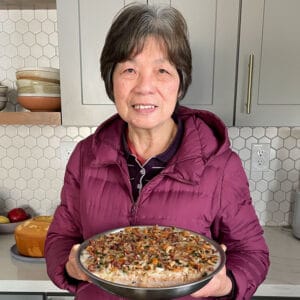 Mama Lin holding peanut cake