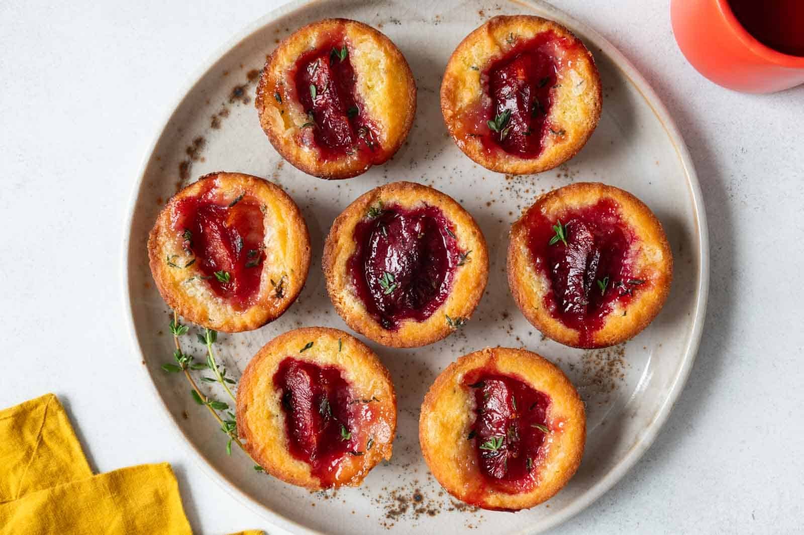Corn mochi muffins with larger pieces of plums cut into smaller pieces